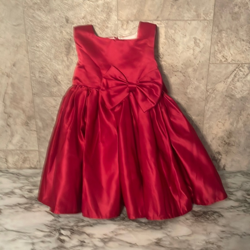 Used size 18-24 months red bow tie dress with detachable bow in the back.